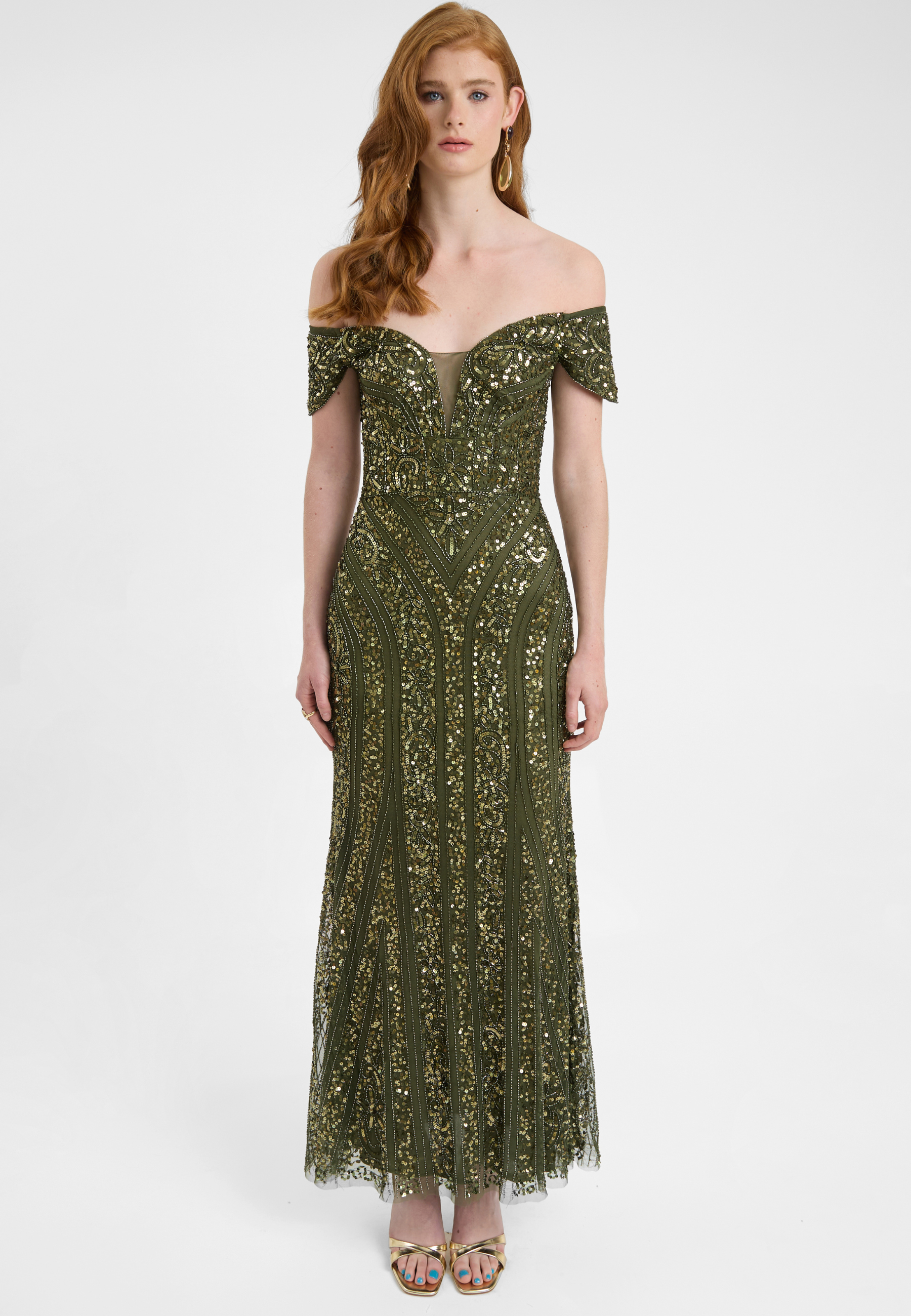 Woman wearing a green off-shoulder evening gown on a white background