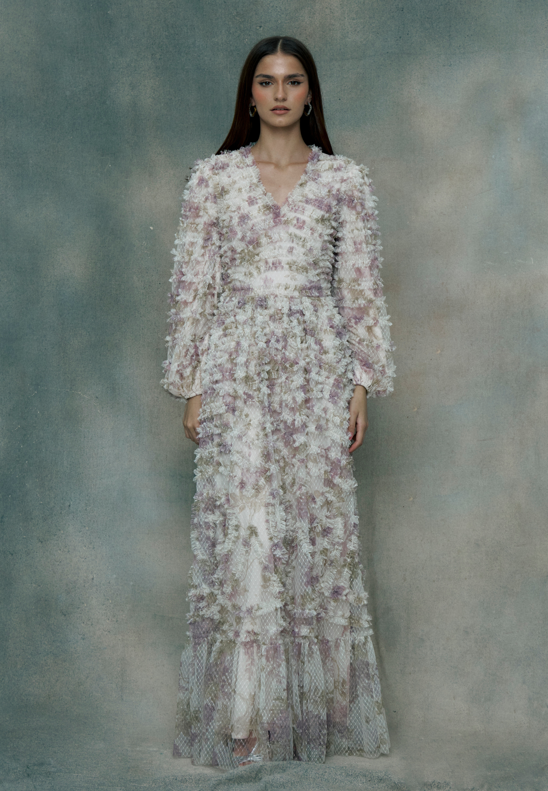 Woman wearing a ruffle maxi dress, designed by BEAUUT