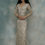Woman wearing a long, elegant dress with sequins, designed by BEAUUT