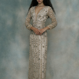 Woman wearing a long, elegant dress with sequins, designed by BEAUUT