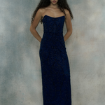 Woman wearing a dark blue strapless gown, designed by BEAUUT