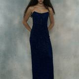 Woman wearing a dark blue strapless gown, designed by BEAUUT