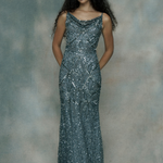 Woman wearing a sparkly silver evening gown, designed by BEAUUT