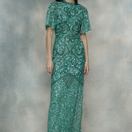 Woman wearing a green sequin dress, designed by BEAUUT