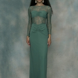 Woman wearing a green chiffon dress with long sleeves, designed by BEAUUT