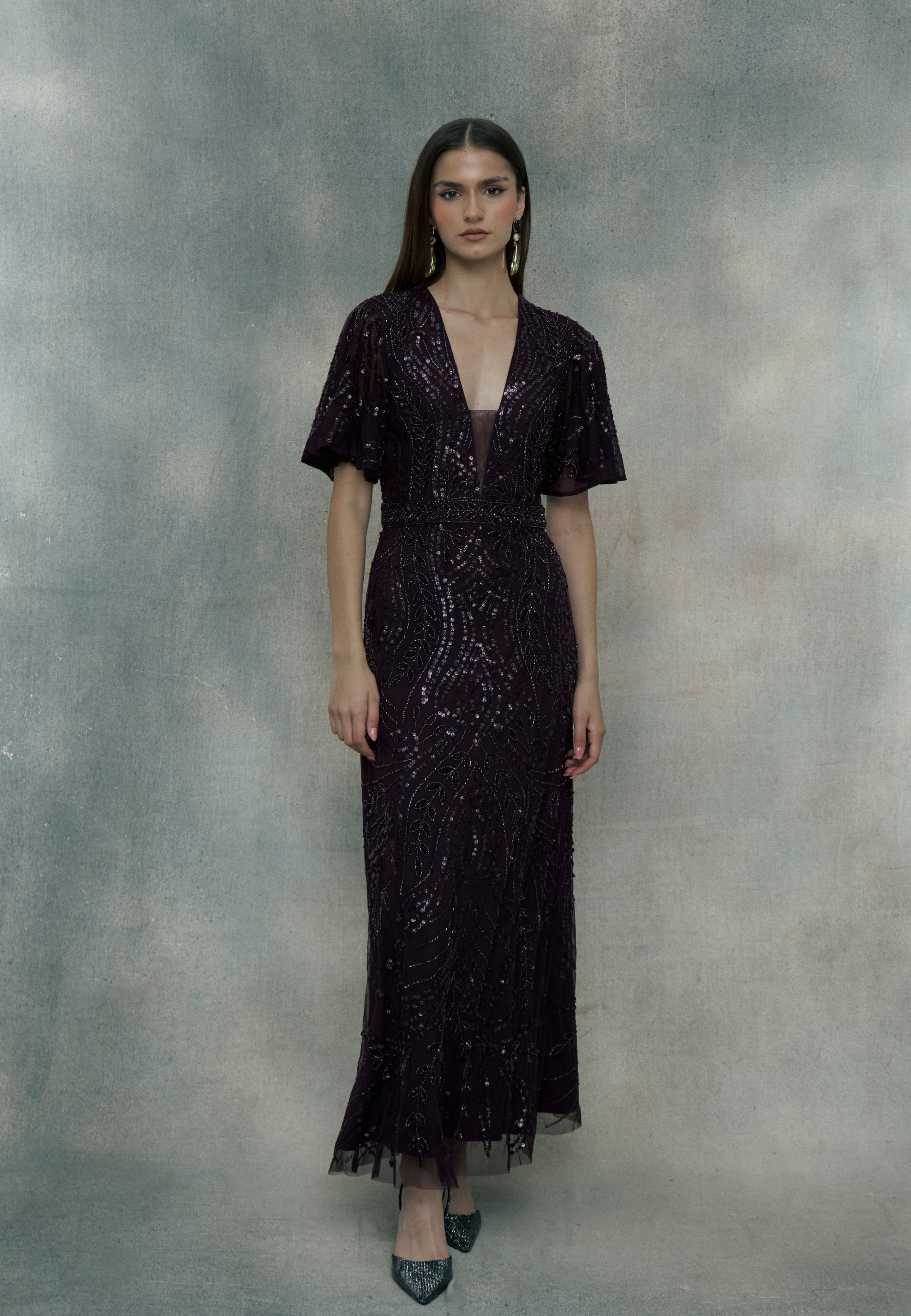 Woman wearing a black beaded dress, designed by BEAUUT