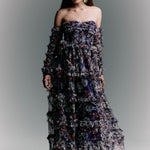 Woman wearing a floral strapless gown against a gray background