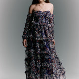 Woman wearing a floral strapless gown against a gray background